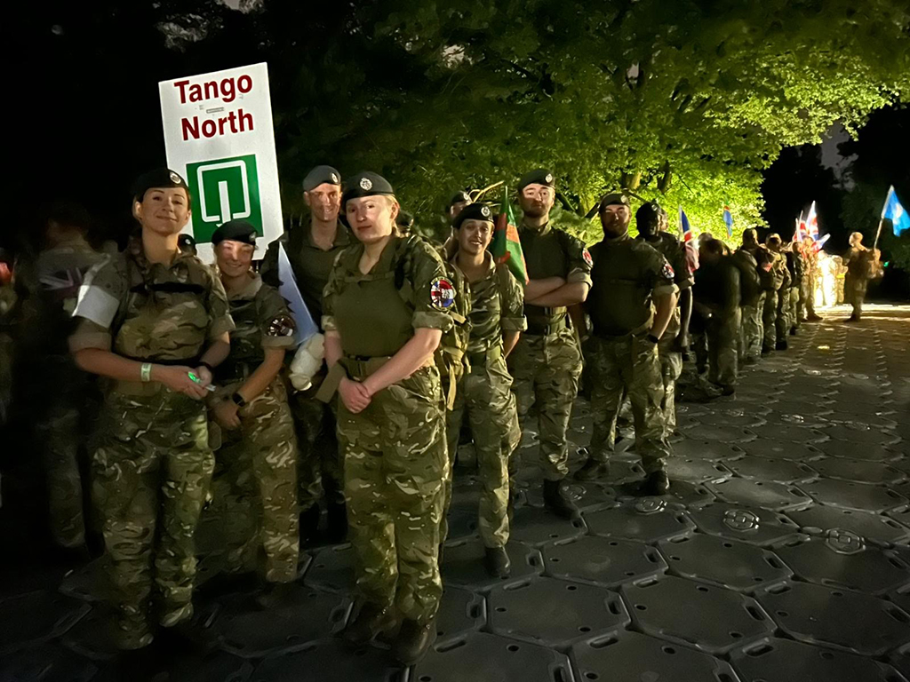 In the dark of a very early morning, the team await the start of a day of walking.